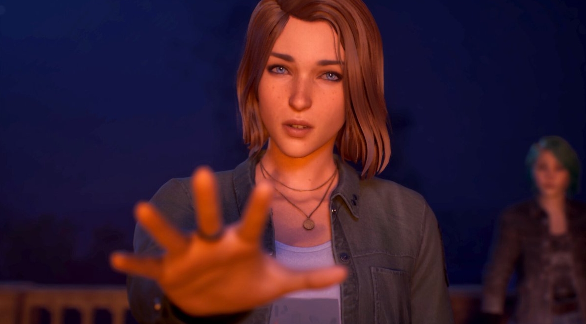 Close-up of a girl reaching out her hand with a focused expression, another girl blurred in the background