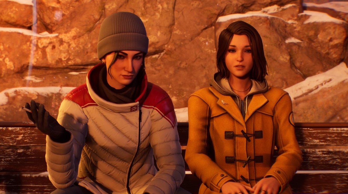 Two girls sitting on a bench in a snowy mountain area, wearing warm jackets and talking