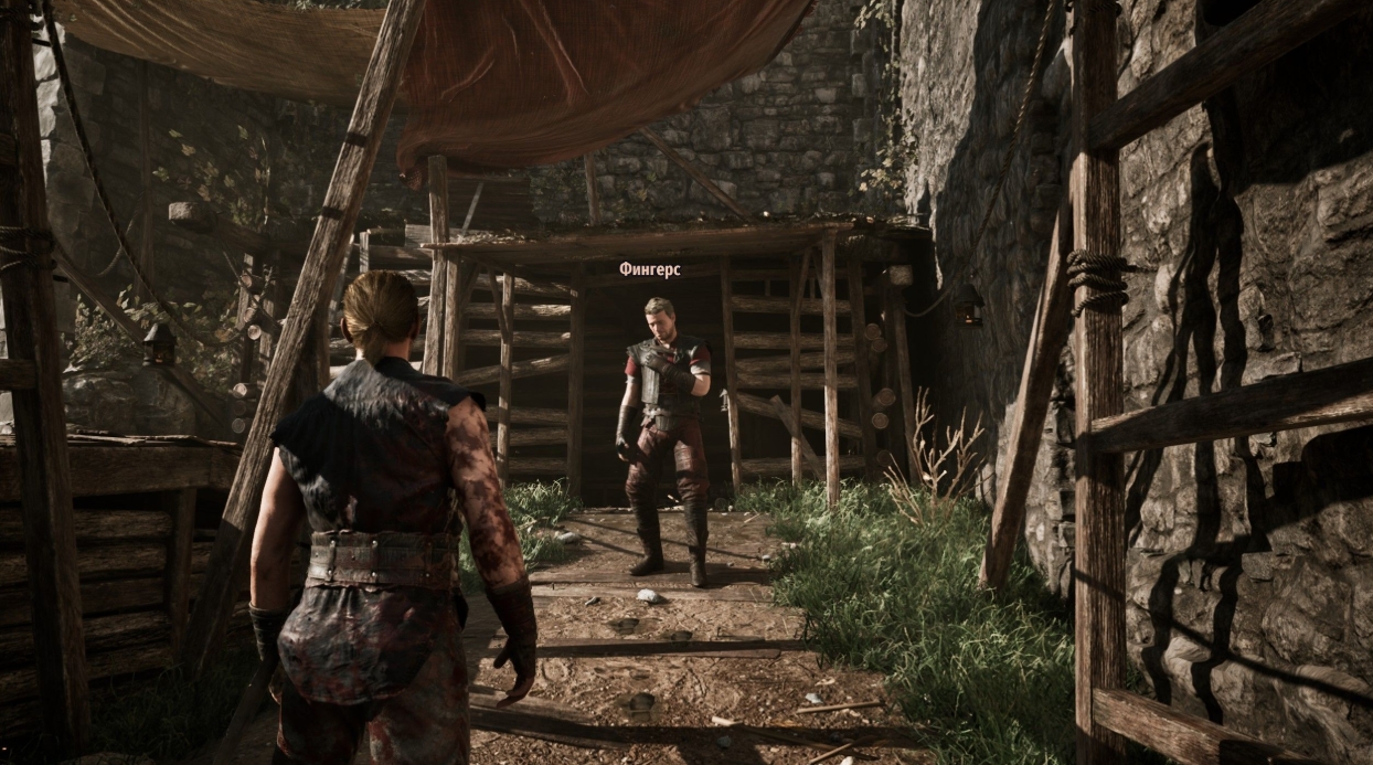 Characters in a Gothic 1 Remake camp near a fire and wooden enclosures and fortifications