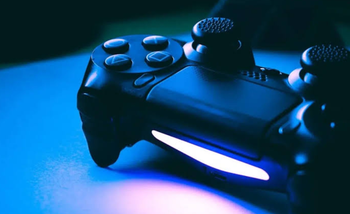 DualShock 4 PlayStation controller illuminated with signature blue light in close-up
