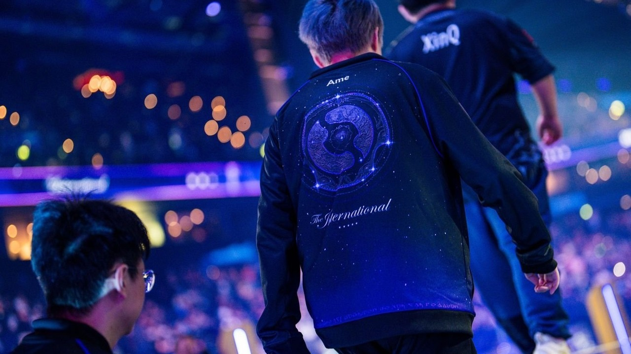 A Dota 2 player walks under blue arena lights